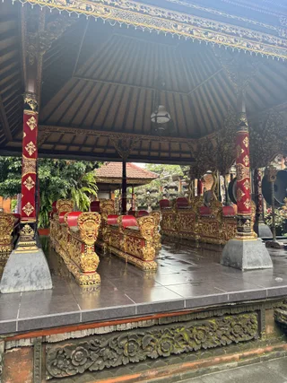 An ornate pavilion with red and gold pillars.