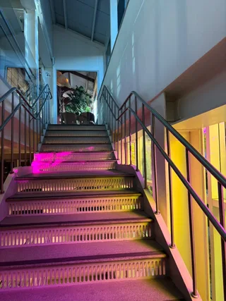 A staircase glowing pink and yellow.